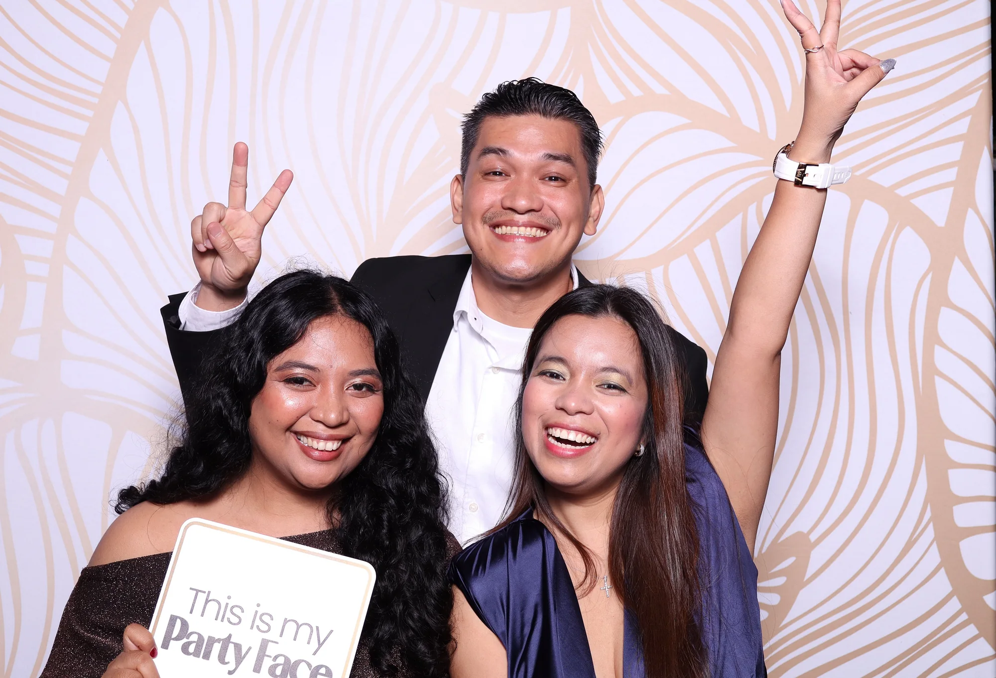 Corporate guests celebrating with props at a RicheMoments activation